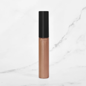Photo of Radical Cosmetics' Primrose Lip Gloss, a soft rosy pink shade with warm undertones and a delicate, dewy finish. This elegant lip gloss delivers a subtle flush of color, blending notes of blush rose and petal pink with a hint of sheer shimmer for a natural, luminous look. The formula is ultra-hydrating, non-sticky, and enriched with clean, skin-loving ingredients. Housed in a clear, minimalist tube that showcases the gentle pink hue. Keywords: primrose lip gloss, rosy pink lip gloss, natural lip gloss, clean beauty lip products, vegan lip gloss, cruelty-free cosmetics, paraben-free lip gloss, hydrating lip color, soft glam lip gloss, blush pink lip gloss, private label lip products, natural makeup essentials, lip gloss for warm undertones, eco-conscious beauty, USA-made cosmetics, Radical Cosmetics lip collection, sheer pink gloss, trending nude lip shades, glossy finish lip gloss.