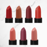 Matte Lipstick Kit featuring seven full-size clean beauty lipsticks in assorted shades including red, nude, brown, and berry tones. Cruelty-free, paraben-free, and made in the USA.