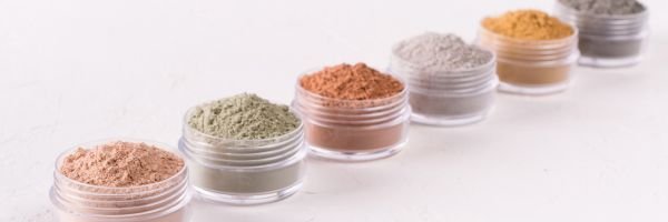 various powders in small acrylic jars.